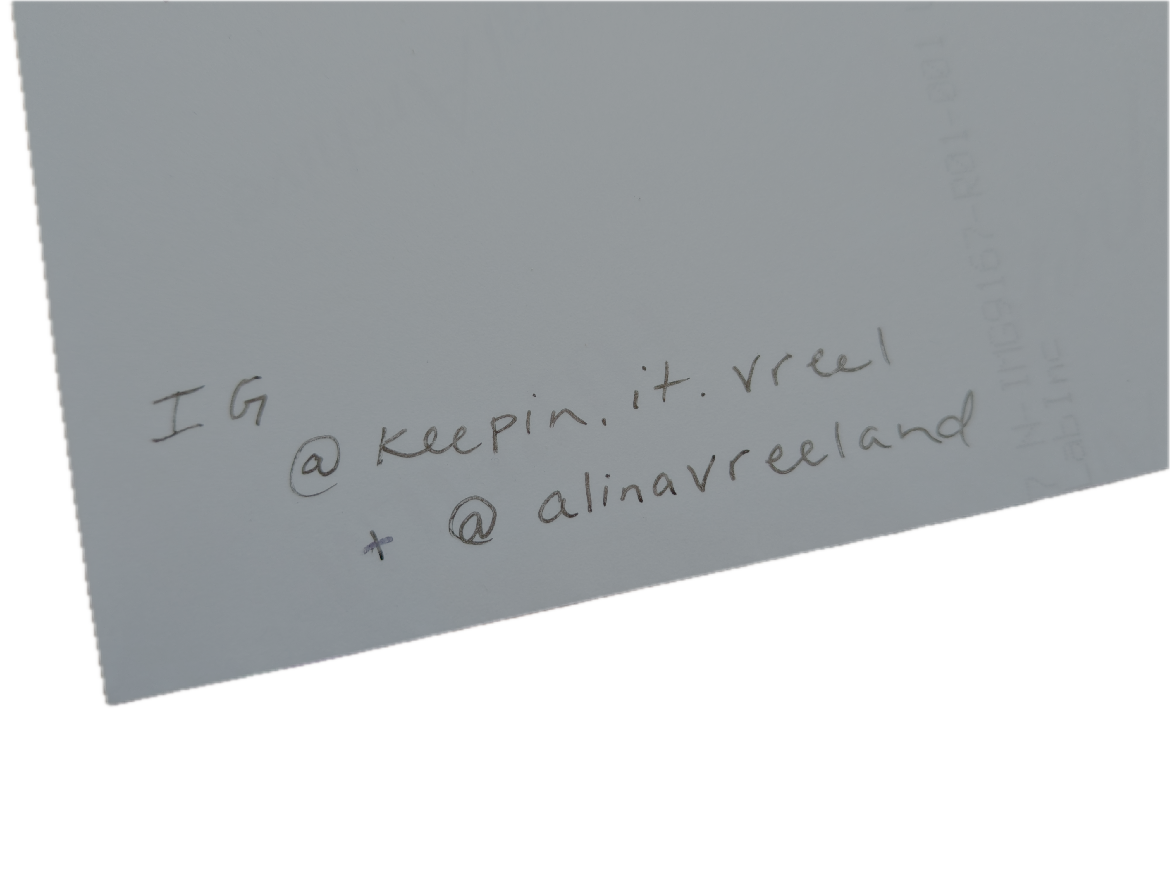 Back of a photograph with Instagram handles